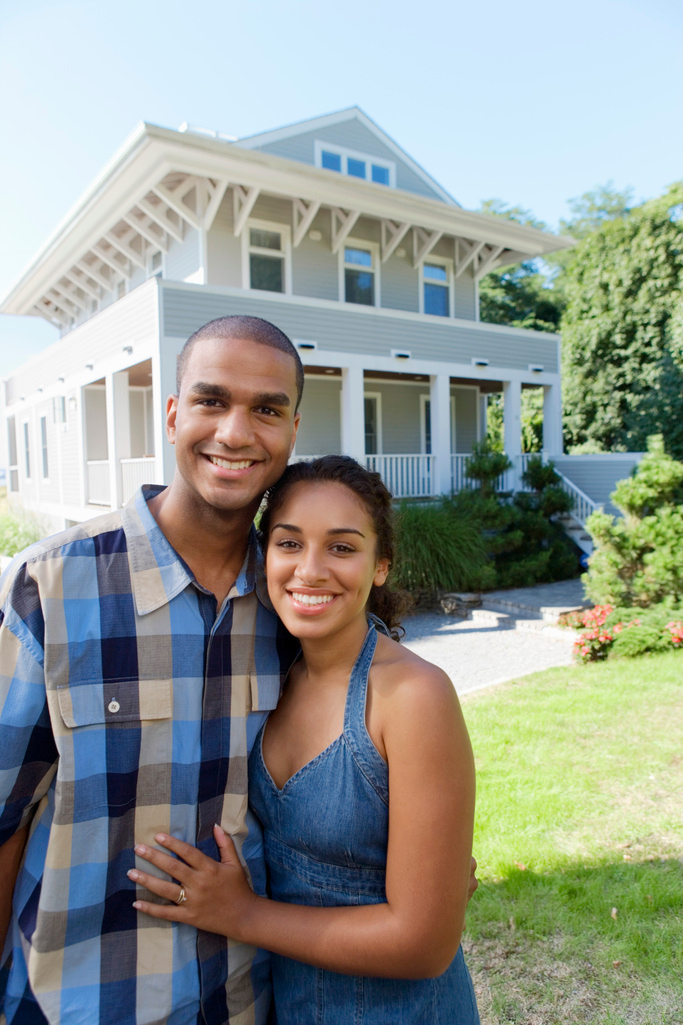 Couple in front of house